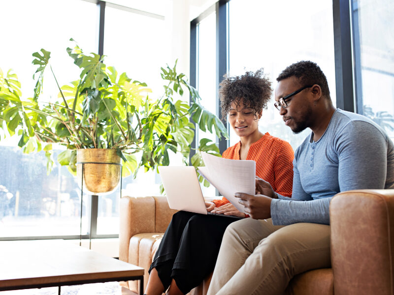 Man and woman looking into papers