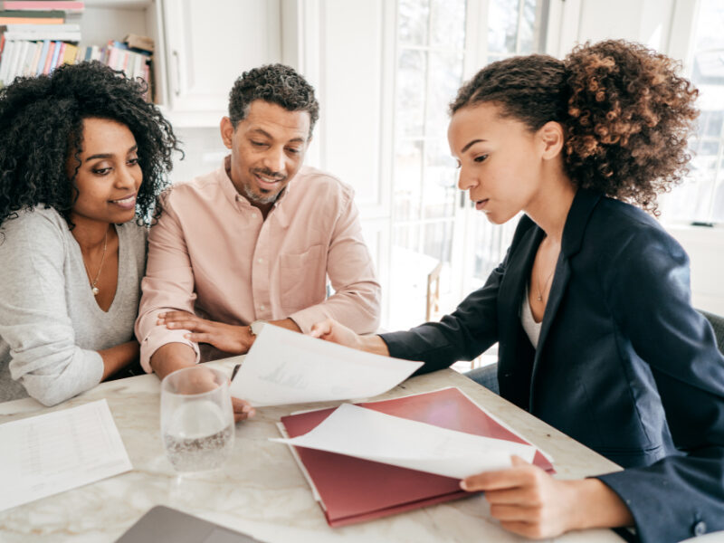 Adviser discussing documents with a couple