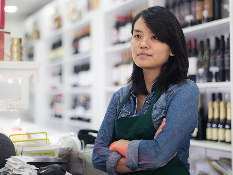 Woman at liquor store looking unimpressed.