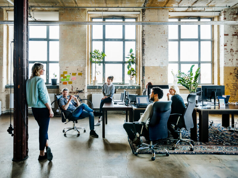 Team of office employees at open office