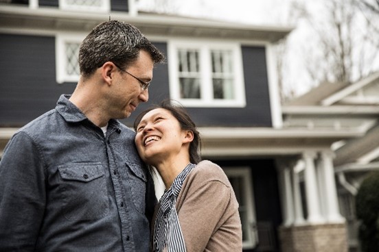 Couple in front of a house