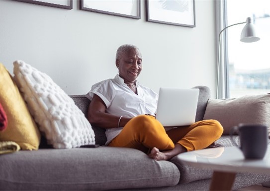 A senior lady looking at her laptop