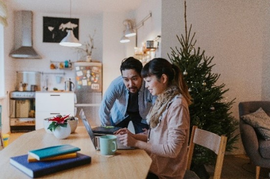 Couple looking into a laptop